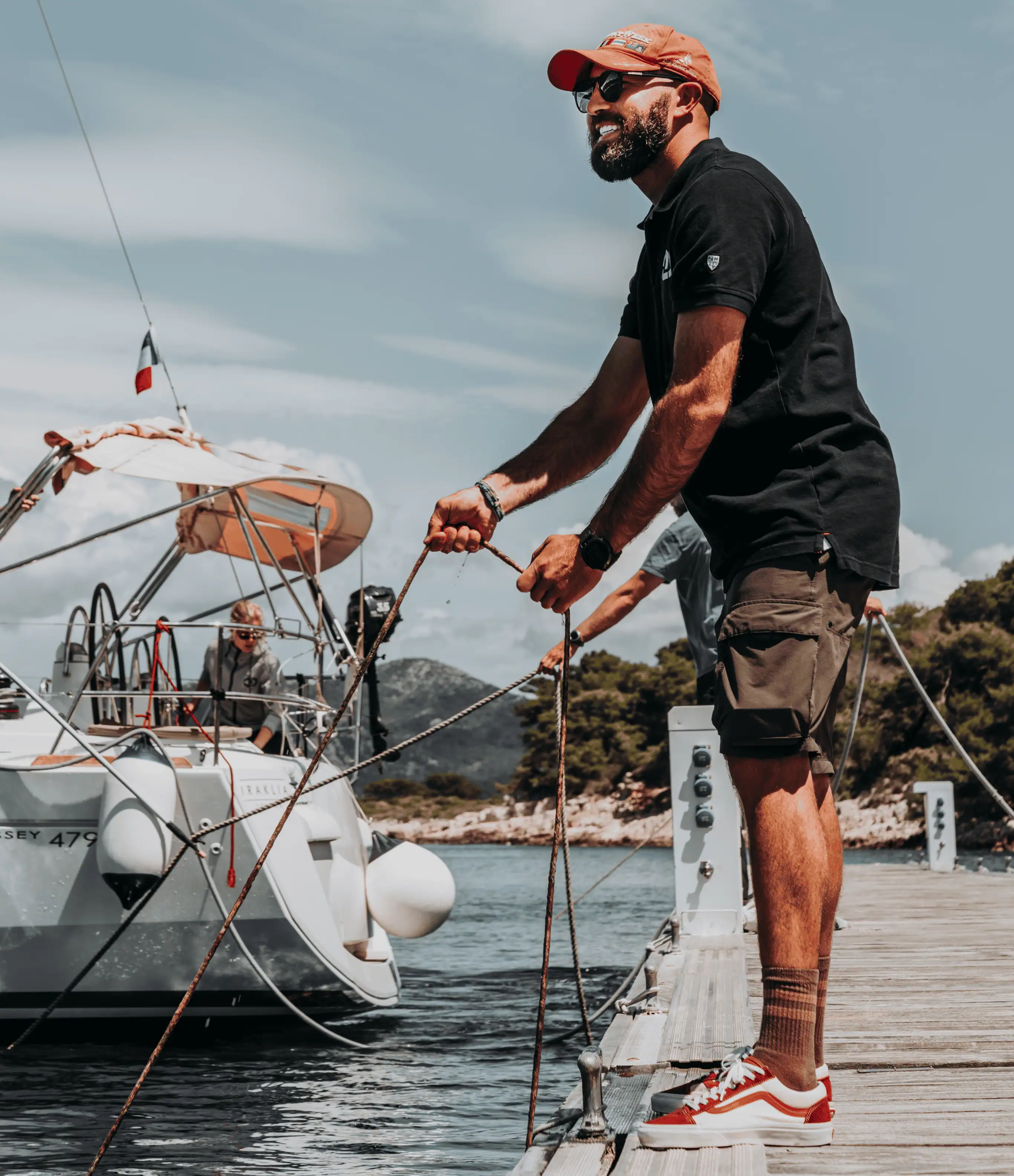 Professional skipper handling mooring lines while docking a yacht