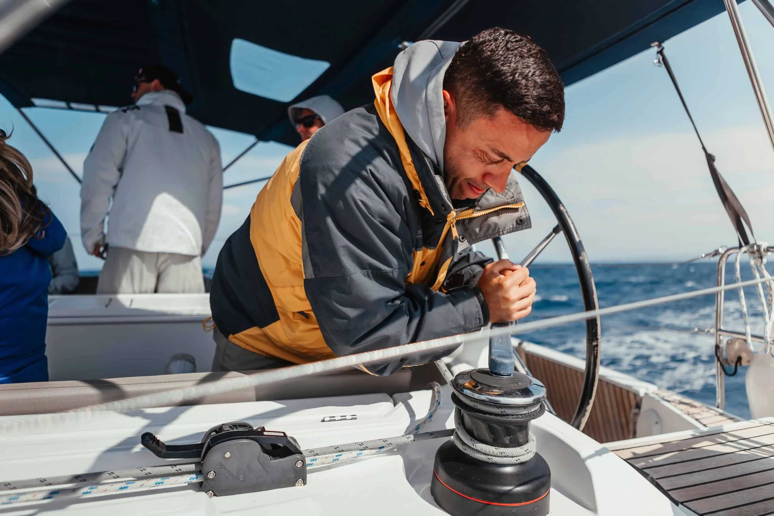 Sailing instructor demonstrating winch handling during training