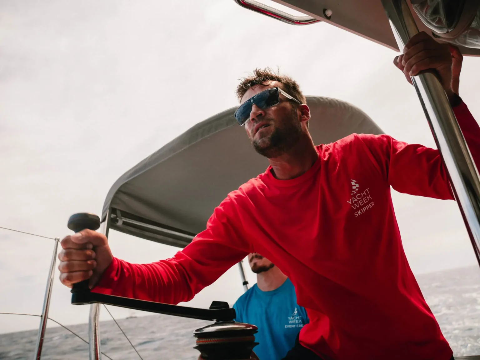 Professional skipper handling a sailing yacht during charter sailing