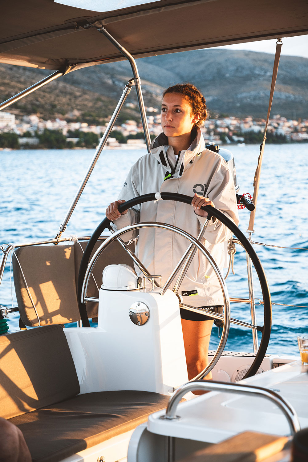 Skipper Academy trainee steering a sailing yacht