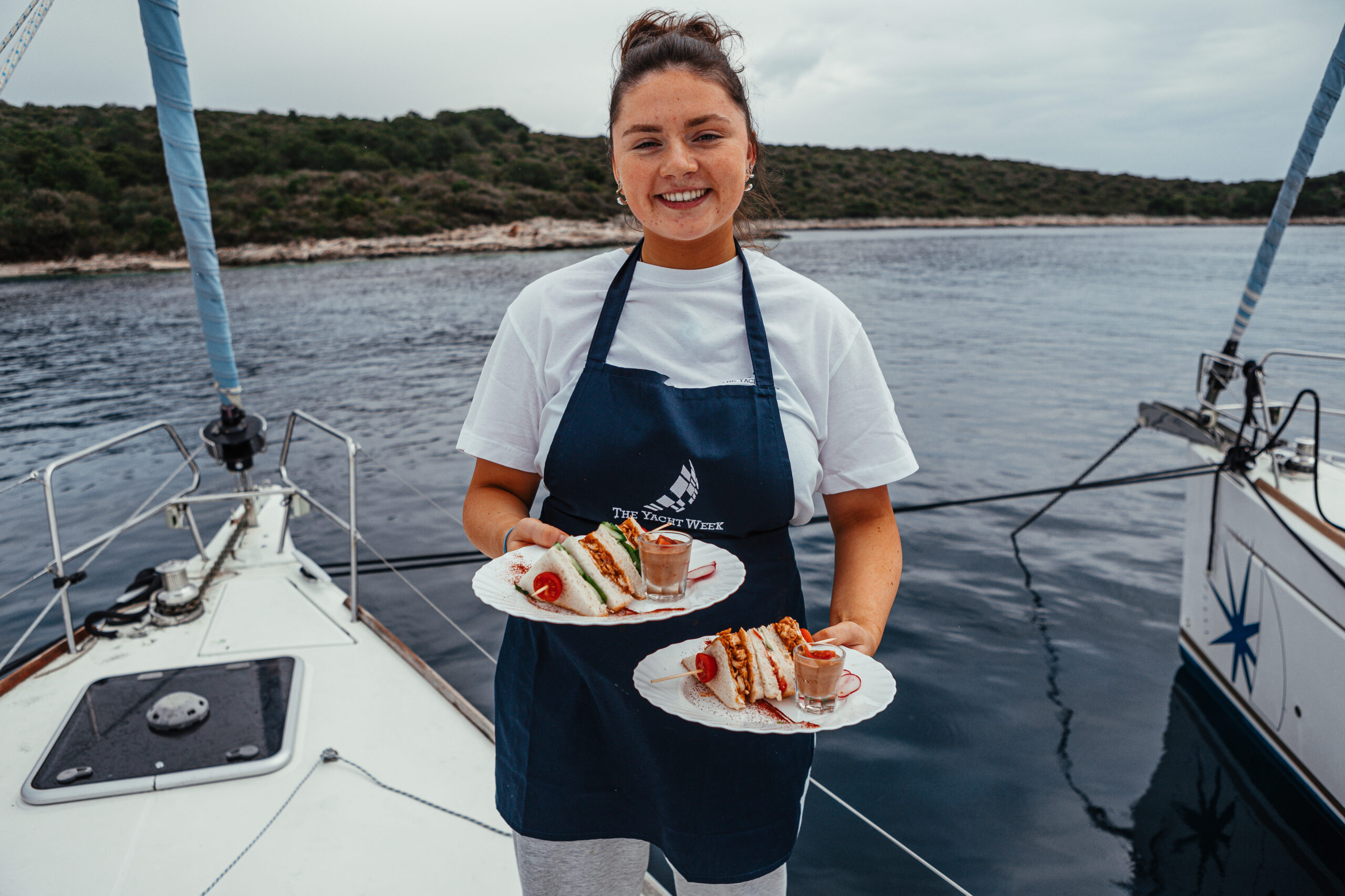 Yacht host serving guests onboard during a charter