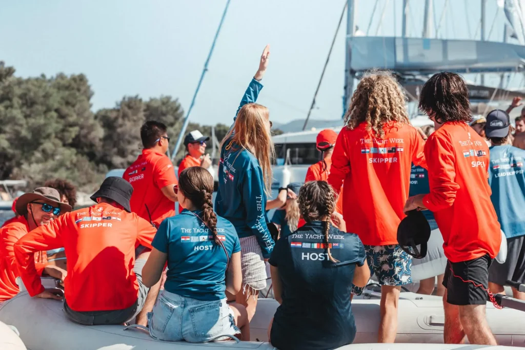 Professional yacht crew members gathered aboard a sailing yacht.