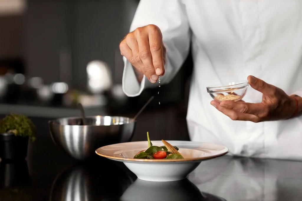 Chalet chef preparing and finishing a gourmet meal for guests