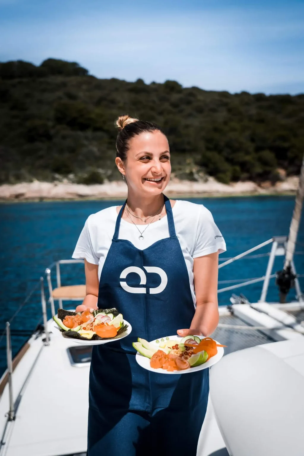 Professional yacht host serving food to guests on deck