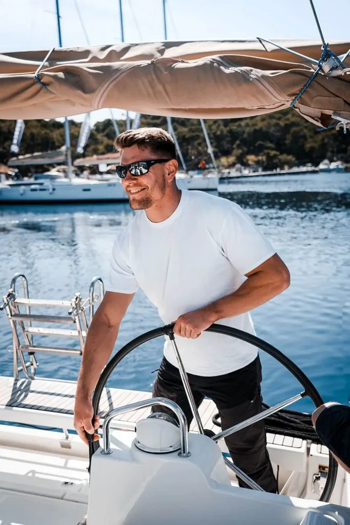 Professional skipper steering a sailing yacht
