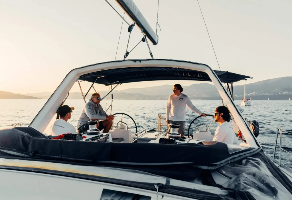 Yacht crew members coordinating operations on a sailing catamaran