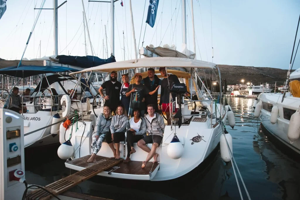 Yacht crew team gathered on a charter yacht in marina