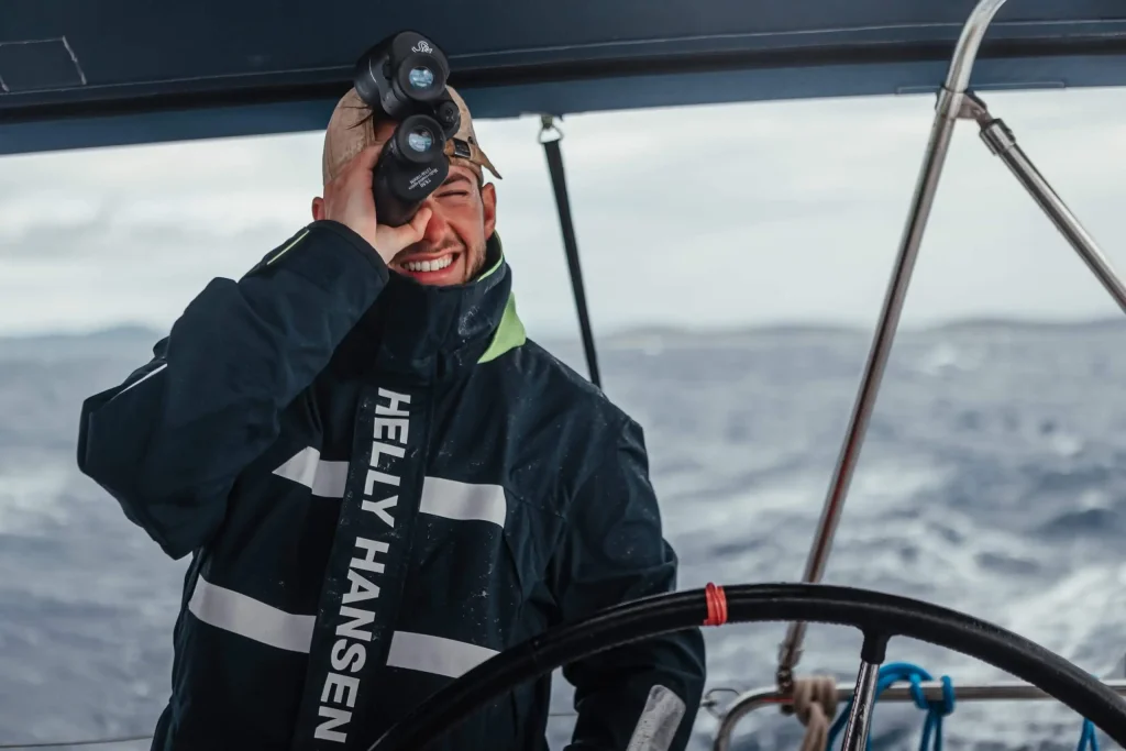 Professional yacht skipper assessing conditions while navigating at sea