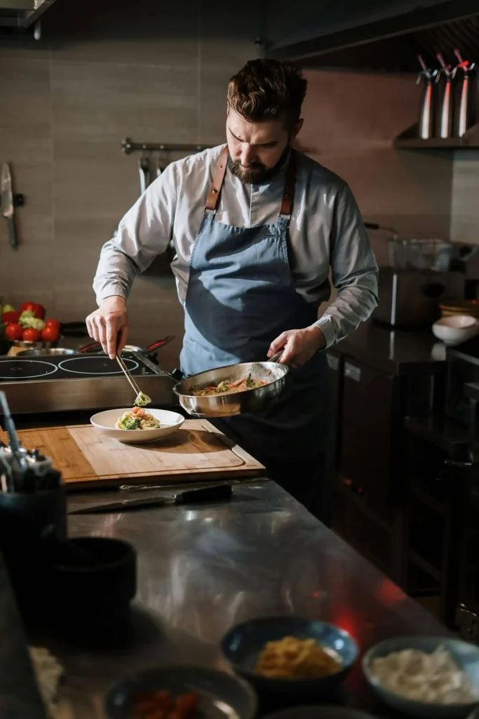 Chalet chef preparing a freshly cooked meal in a professional kitchen