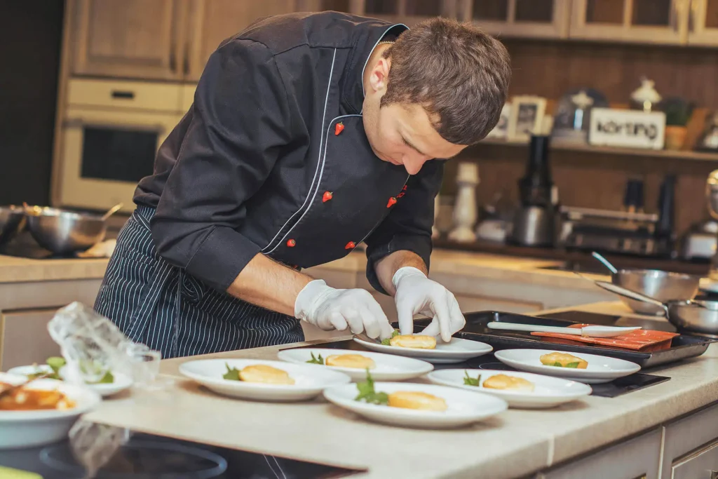 Chalet chef plating individual meals for guest service
