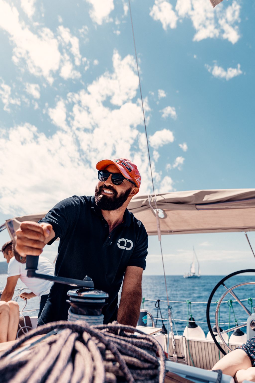 Professional skipper handling a sailing yacht during charter sailing