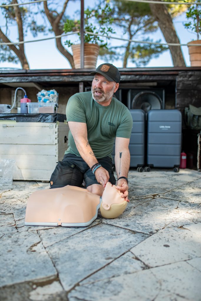 Skipper Academy instructor demonstrating airway management techniques on a training mannequin during a first aid and safety module.